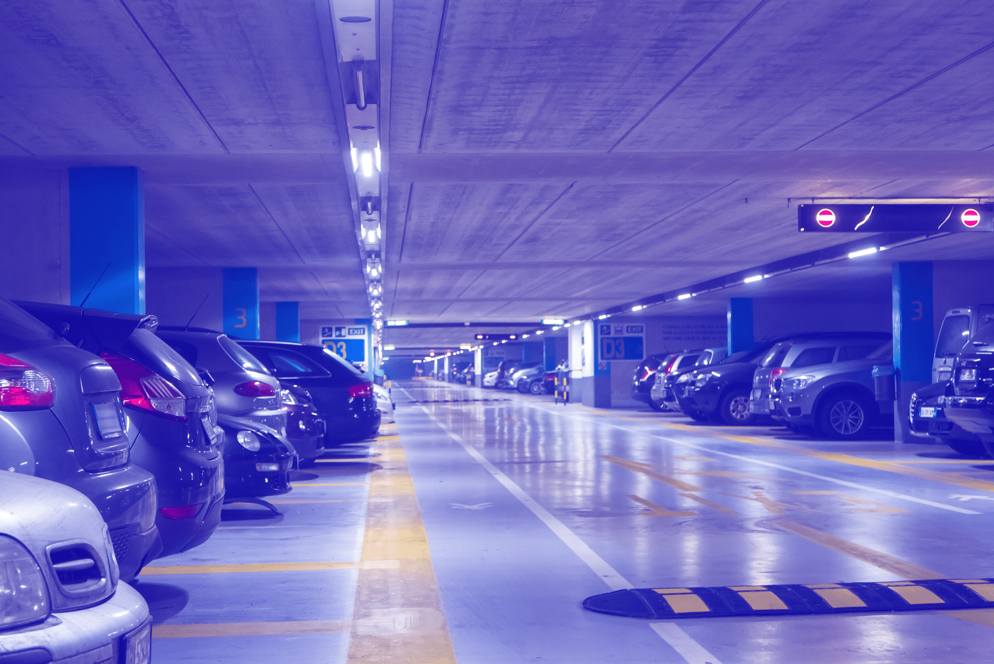A professional parking garage with cars parked in it.