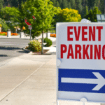 A blue and white event parking sign on the side of a street.