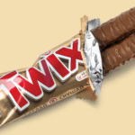 Twix chocolate bar on a beige background.