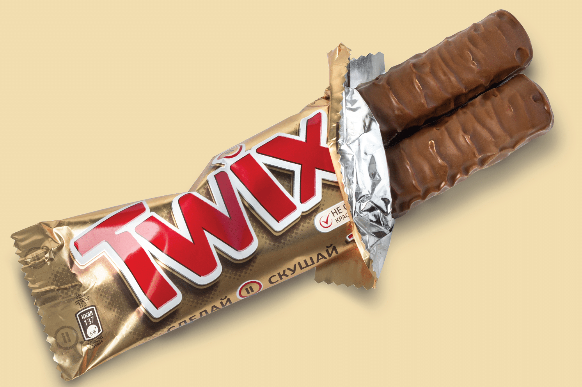 Twix chocolate bar on a beige background.