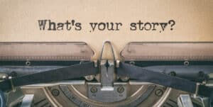 An old typewriter with the words what's your story? inviting storytelling.