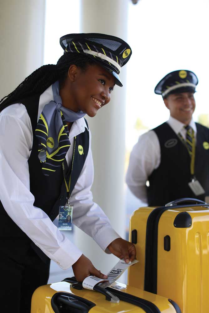 African american woman tagging luggage
