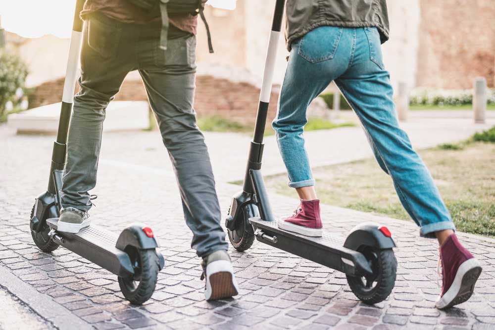 people riding electric scooters