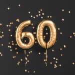 Number 60 in gold balloons
