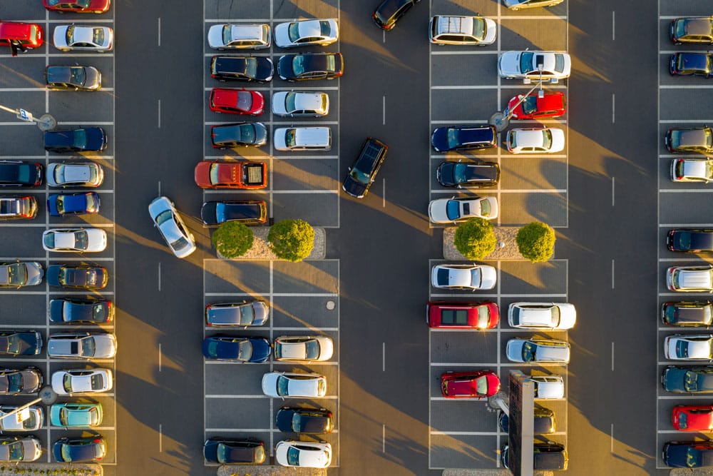 Top down view of parking lot with many cars