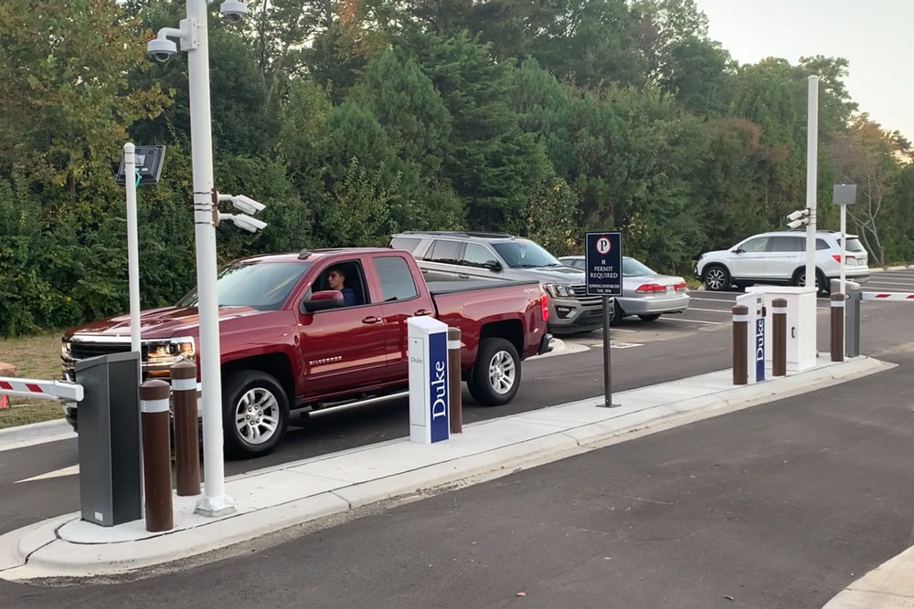 Red pickup truck leaving a Duke University parking lot