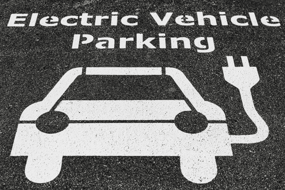 An electric vehicle parking sign indicating the presence of EV Charging Stations.