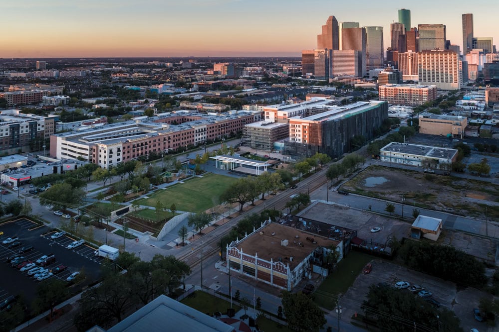 An aerial view of downtown Houston at sunset, highlighting the stunning cityscape.