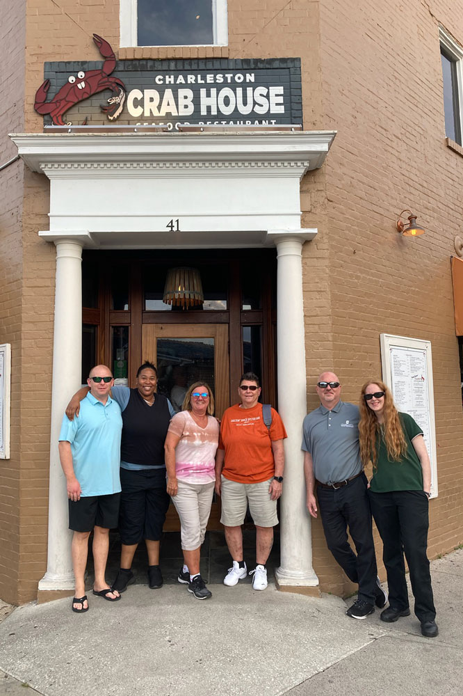 A group of people in front of the crab house during CPMA's Regional Spotlight event.