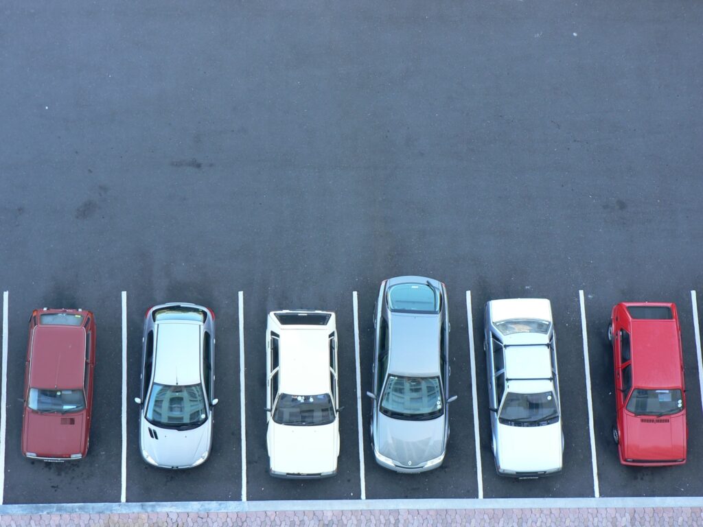 A group of cars parked in a parking lot as part of the formulation of a developing curb management strategy.