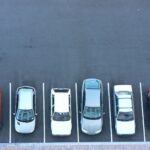 A group of cars parked in a parking lot as part of the formulation of a developing curb management strategy.