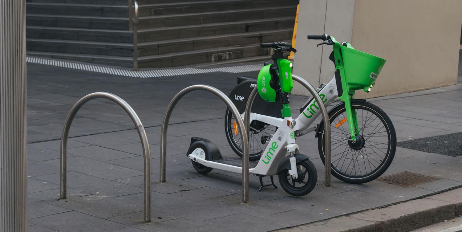 Photograph of a parked scooter and bike