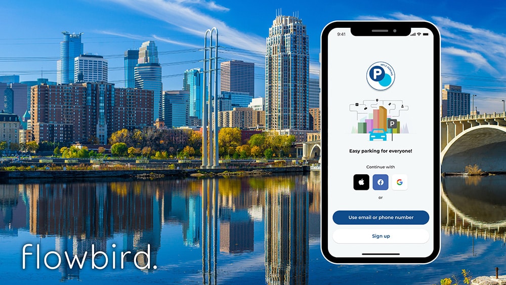 Image of phone with Flowbird app in front of Minneapolis skyline