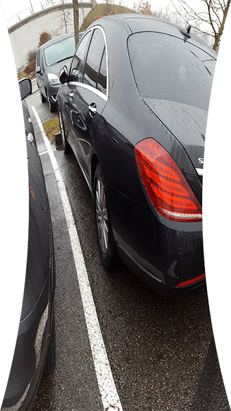 Squeezed image of car parked in a tight spot