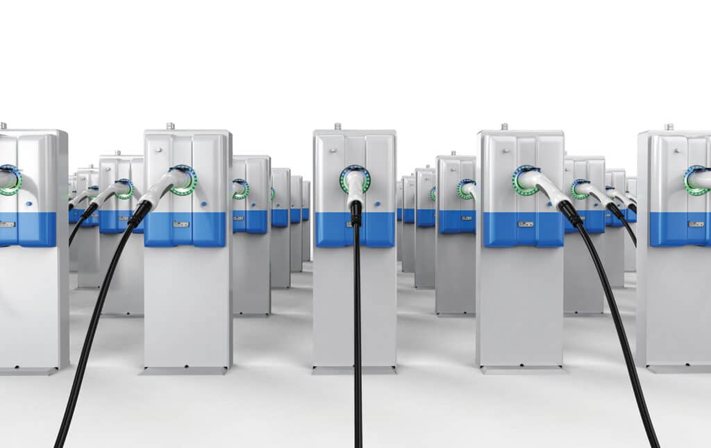A row of electric charging stations with blue and white cables.