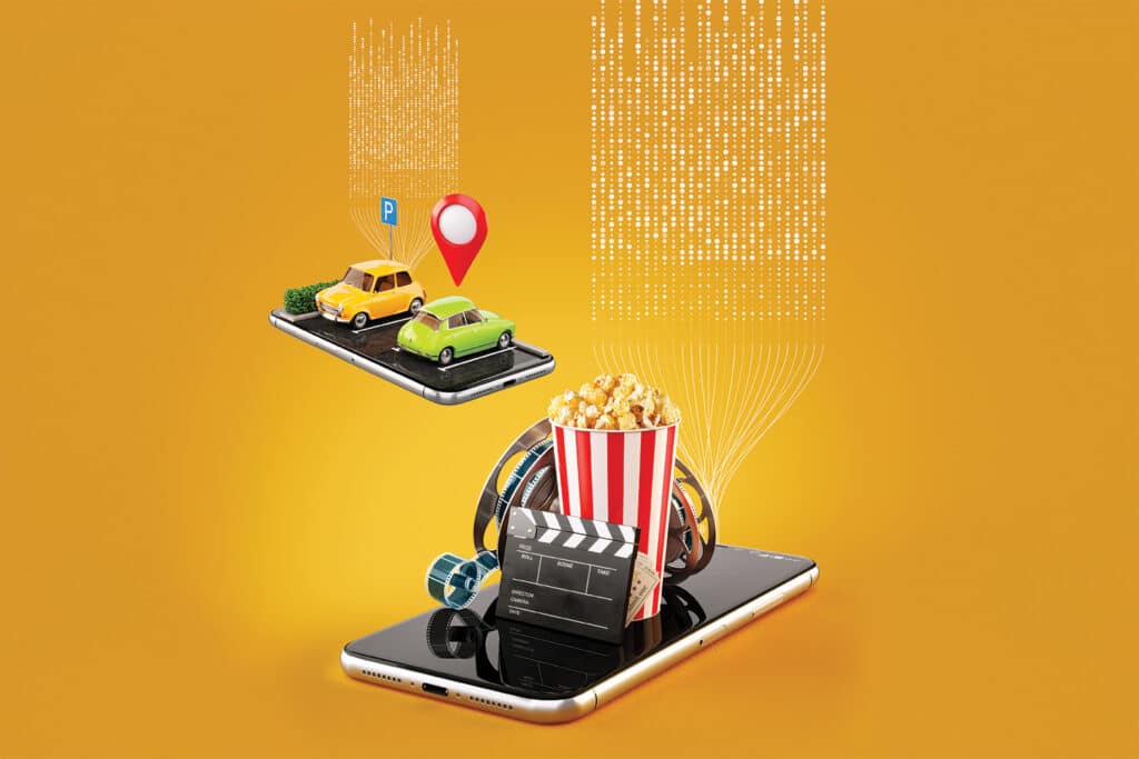Illustration of cars parked on a mobile phone and what appears to be movie theater popcorn. Over a yellow background with abstract digital markings representing data.