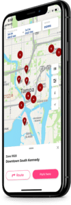 Large image of a mobile phone running the Flowbird app showing a map of Tampa, Florida with parking spots marked on it.