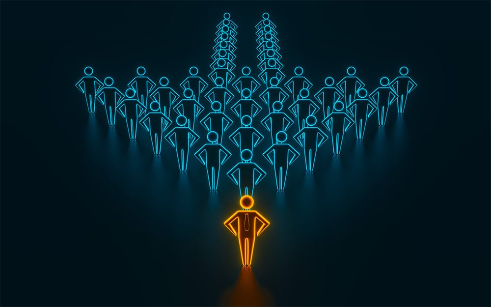 Illustration of a crowd of blue people icons forming the shape of an arrow with an orange person standing in front. Concept of leadership.