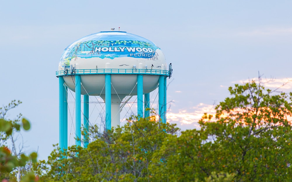 A blue and white water tower that reads Hollywood Florida.