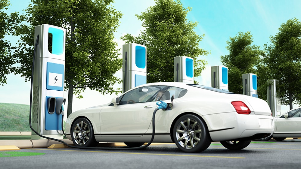 Electric cars plugged into charging stations.
