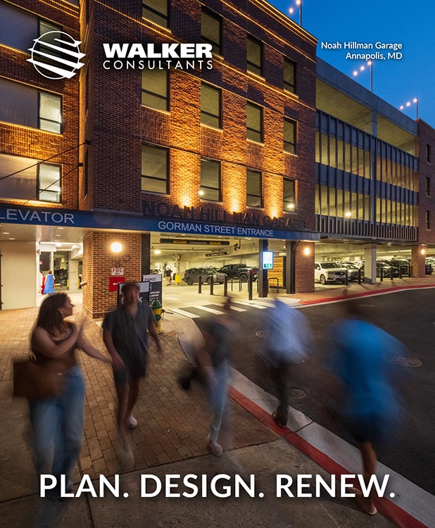 A group of people walking past the illuminated entrance of the noah hillman garage in annapolis, md during twilight with the slogan "plan. design. renew." by walker consultants.