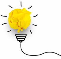 creative idea concept - yellow paper balled up to look like light bulb